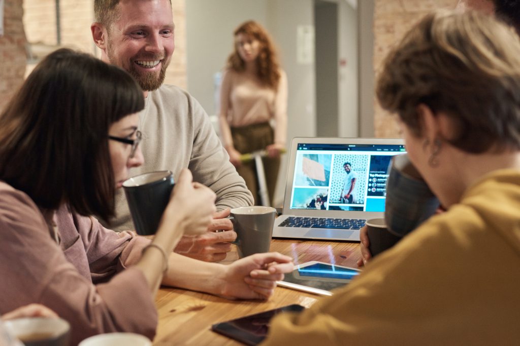 Three people browsing the internet on a computer