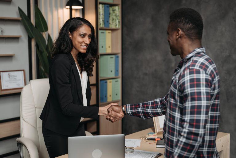 A woman shaking a man's hand