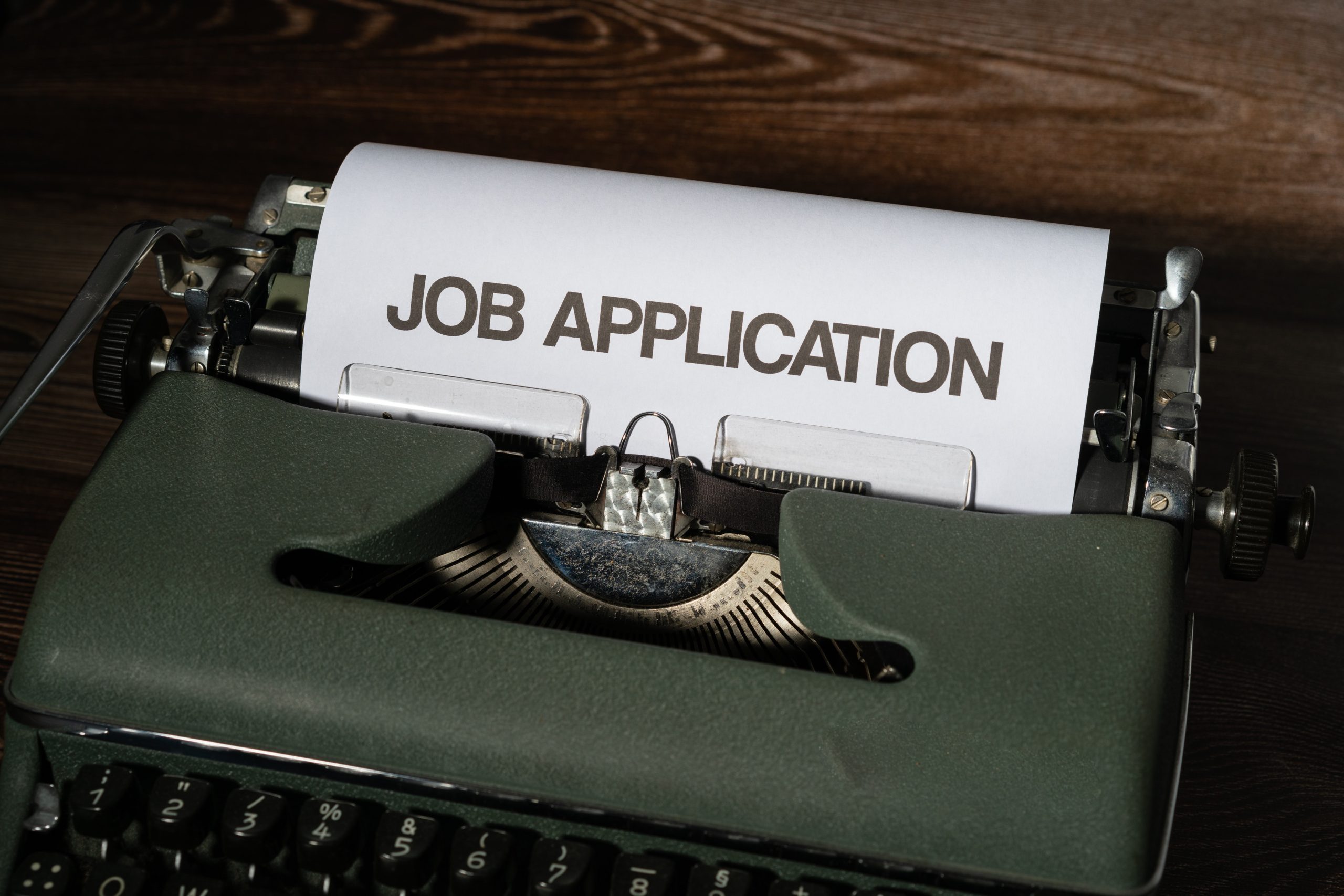 A typewriter with the words "Job Application" written on a piece of paper