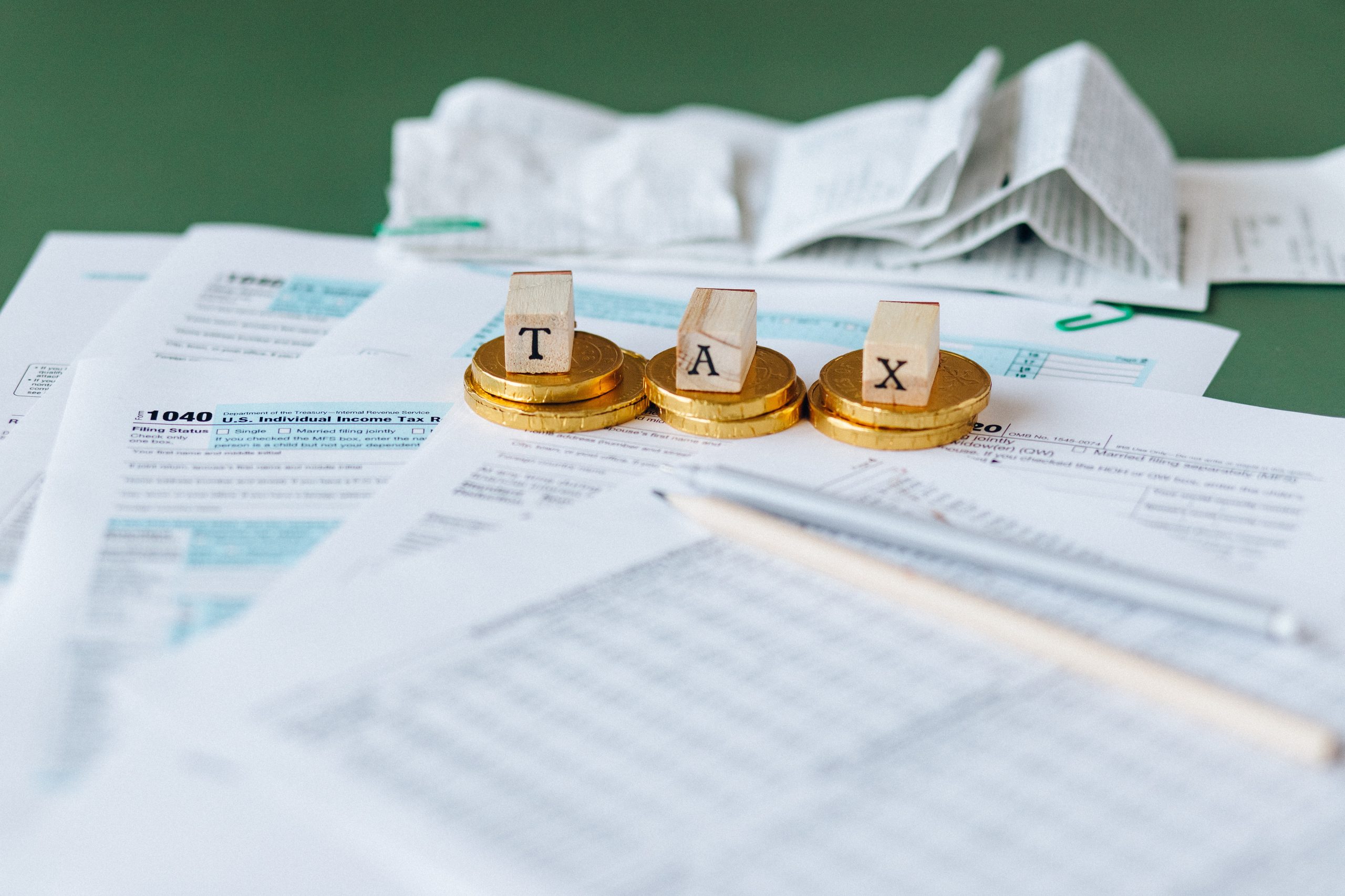 The word TAX spelled out on a desk